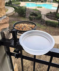 Two Pack Plastic Round Bird Feeder Bowls For Wild Birds Seed Tray And Water Bowl At Feeding Stations Easy To Clean Clear Water Visibility Attract Birds installed on a garden fence.