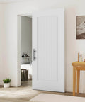 36x84 Concealed Barn Door With Soft Close Hardware Kit installed in interior space, white primed solid core, brushed stainless steel pull