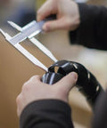 Go-To Safe-Spiral Pre-Cut Spiral Wrap For Hoses And Cables Black HD-PE 0.50 Inch OD By 25 Foot Pre-Cut Length in use with calipers.