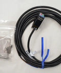 Keyence PZ2-42 Diffuse Reflective Short Range Photoelectric Sensor With Red LED Detects Transparent And Opaque Targets 100 mm Range New In Box Ready To Install Must Have, shown with attached cable and mounting kit.