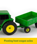 1 To 64 Scale Die Cast Farm Toy Playset with 70 Pieces including tractors, trucks, farm animals, tools, a farm shed and more, close-up of green tractor with pivoting wagon axle