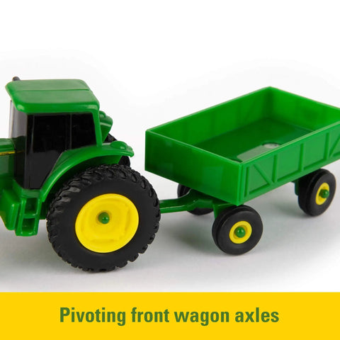 1 To 64 Scale Die Cast Farm Toy Playset with 70 Pieces including tractors, trucks, farm animals, tools, a farm shed and more, close-up of green tractor with pivoting wagon axle