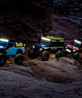 RC cars with Pro Scale Advanced Lighting Control System Power Module and Distribution Block for RC Cars 6591 Black on rocky terrain