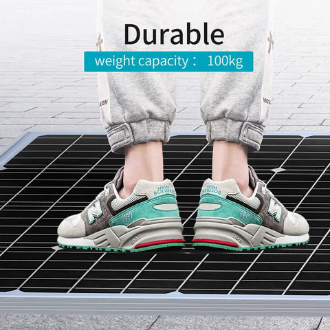 Person standing on solar panel demonstrating durability, part of 1800W Home Grid Tie Solar Kit With 15X120W Monocrystalline Panels.