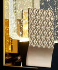 Slick Modern Crystal Wall Sconce Lights For Cozy Bedroom And Living Room Vibes With Up Down Led Wall Lamp Fixtures In A Solid 2 Pack For Indoor Outdoor Bathroom Decor; close-up of textured base and clear crystal shade.