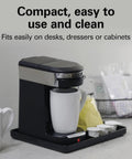 Compact 1 Cup Coffee Maker For Office Use on desk, single serve pod brewer, black and stainless steel, with mug, 3 minute brew time.