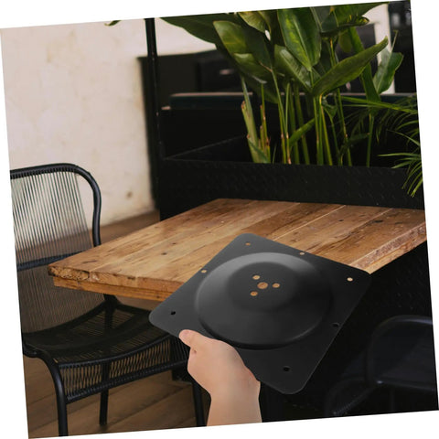 Heavy Duty Cast Iron Table Leg Connectors Lock Down Wobbly Furniture Fast No Sweat Rock Solid Stability, matte black bracket in hand.