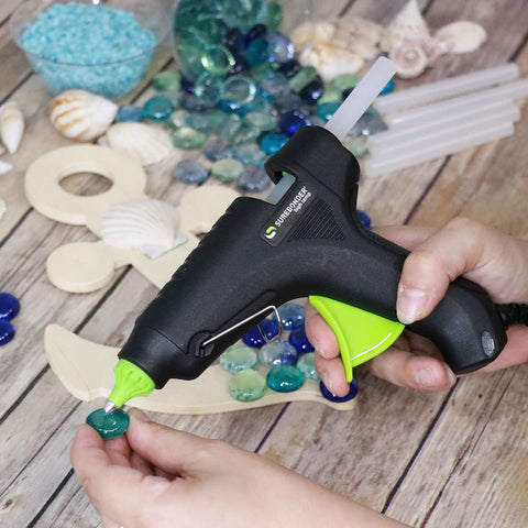 Person using Full Size Hot Glue Sticks 50 Pack Clear Non Toxic Multi Temp 4 Inch By 0.43 Inch for DIY crafts with a glue gun