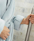 Person holding Heavy Duty 16 Inch Bathroom Grab Bar With Curled Grip In Brushed Nickel Finish for stability and safety