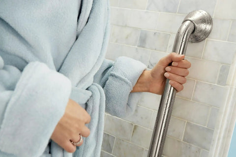 Person holding Heavy Duty 16 Inch Bathroom Grab Bar With Curled Grip In Brushed Nickel Finish for stability and safety