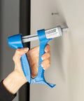 Using Drywall Repair Kit With Built In Spatula Tool And Two 20ml Spackling Paste Cartridges To Fill Nail Holes And Cracks on wall.