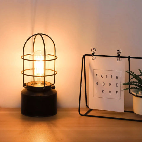 Industrial Table Lamp With Touch Control And 3 Way Dimming on wooden desk, vintage iron cage design, lit Edison bulb ambiance