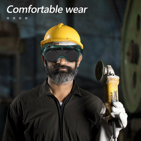 Man wearing Top Shelf Flip Up Welding Goggles With Anti Scratch Lens For Metalwork And Industrial Eye Protection with a protective helmet.