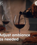Person pouring wine into a glass, demonstrating ambiance adjustment with Smart LED Edison Style ST19 Bulb Pack Of 4 That Plays Nice With Alexa