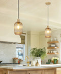 Two Pack Top Tier Amber Cylinder Pendant Lights With Vintage Ribbed Hand Blown Glass And Brushed Gold Adjustable Fixtures Serving Big Kitchen Island Or Dining Room Vibes in stylish kitchen setting.