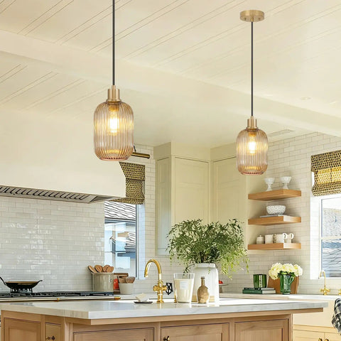 Two Pack Top Tier Amber Cylinder Pendant Lights With Vintage Ribbed Hand Blown Glass And Brushed Gold Adjustable Fixtures Serving Big Kitchen Island Or Dining Room Vibes in stylish kitchen setting.