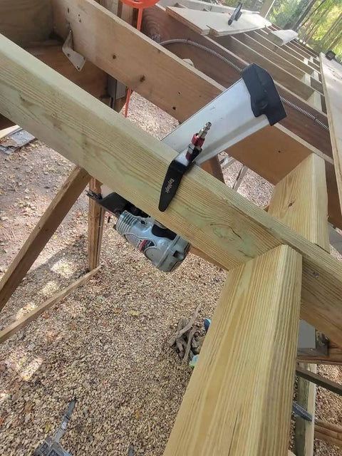 Steel Pneumatic Rafter Hook Hanger With One Quarter Inch Air Tool Swivel Fitting securing air nailer to wooden rafter