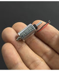 Mini Round 10mm Solenoid Electromagnet With 7.4V 9V 12V DC, held in hand, showing suction push-pull type and 5.5mm plunger stroke.