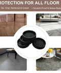 Image of four black 2-inch round non-slip furniture pads on a hardwood floor. No Slip Furniture Pads 2 Inch Round Rubber Caster Cups Thick Silicone Coasters For Hardwood Floors Anti Slip Bed Couch Stoppers To Prevent Sliding Black Four Pack.