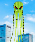 Totally Ultra Large 26ft 3D Octopus Foil Kite With 1000D String flying in cityscape, bright green with black stripes.