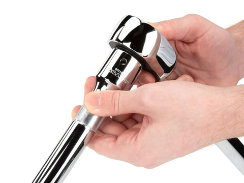 Hands gripping the quick-release ratchet from the Three Fourths Inch Drive Six Point Socket And Ratchet Set, 26 Piece Shallow Metric Sockets 19 To 50 Mm