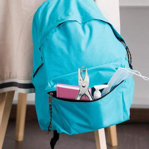 Quarter Inch Handy Hole Punch For Craft Paper And Tags in school bag with books and sanitizer
