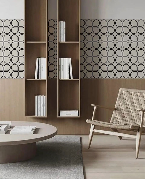 Scandinavian-inspired living room with geometric wallpaper, open wooden shelves, beige woven chair, and modern circular coffee table.