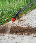 1-Gallon Handheld Farm and Garden Sprayer With Easy Fill Funnel Top spraying ants on grass edge near concrete