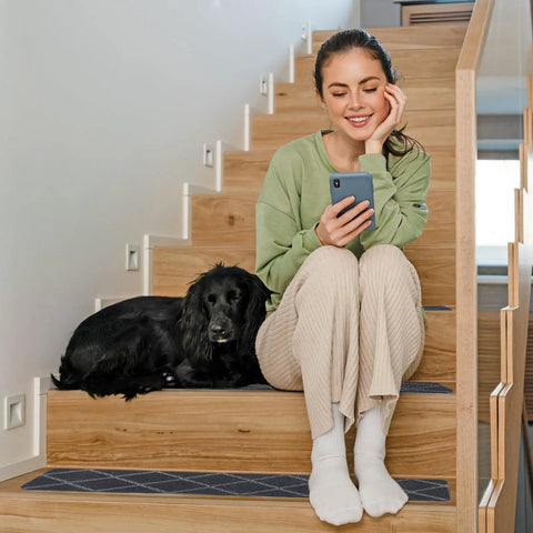 Indoor Stair Treads 15 Pack for Wooden Steps Non Slip Carpet Treads on stairs with woman and dog, gray plaid runner mats visible
