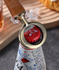 Stainless steel bottle opener insert with wooden handle, installed around a beer bottle neck and crown cap.