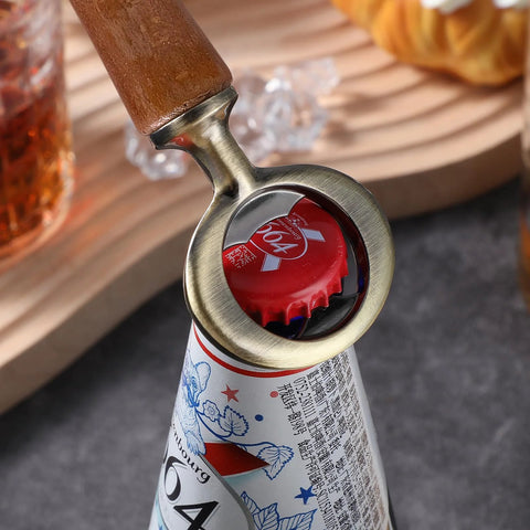Stainless steel bottle opener insert with wooden handle, installed around a beer bottle neck and crown cap.