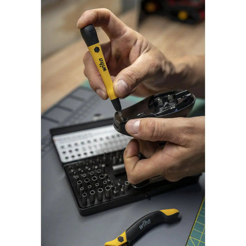 Hands using 65 Piece System 4 ESD Safe Master Technician Ratchet And MicroBits Set Built For Pros With 72-Tooth Ratchet on device