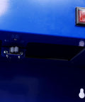 Close-up of Rugged Bench Parts Cleaner With 14L Tank Capacity And 120V High Flow Pump control switch and blue cabinet surface.
