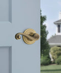 Lido Entry Door Lever With SmartKey Re-Key Security, Antique Brass Finish, Reversible for Left or Right Handed Doors on blue door