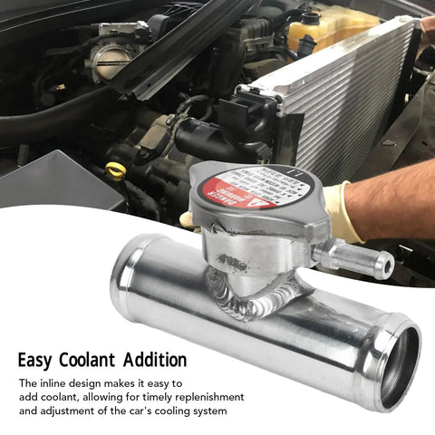 Must Have Inline Aluminum Radiator Hose Filler Neck Cap 32mm 1 And A Quarter Inch 16 PSI Durable Alloy Coolant Fitting For Quick Fill And Reliable Engine Cooling Performance shown installed in a car's engine bay.