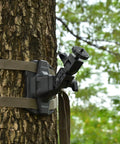 Trail Camera Mounting Bracket With 1/4-20 Threaded Insert 360 Degree Rotating Adjustable Holder attached to a tree with straps.