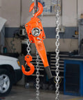 Side view of VEVOR manual lever chain hoist, 3-ton capacity, orange steel body with load hook and hanging chain.