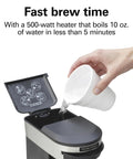 Compact 1 Cup Coffee Maker For Office Use being filled with water, showing open lid, black and stainless steel design.