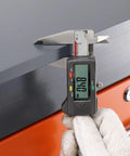 Measuring the thickness of the 8mm steel top on the Heavy Duty Workshop Maintenance And Assembly Workbench With Mounting Vise.