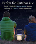 Two people sitting outdoors at night with Grab And Go Rechargeable LED Lantern With 2000mAh Battery, glowing softly.