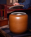 Hella Durable Ceramic Cereal And Rice Dispenser With Seamless Airtight Lid, wide mouth opened with rice inside on wooden table.