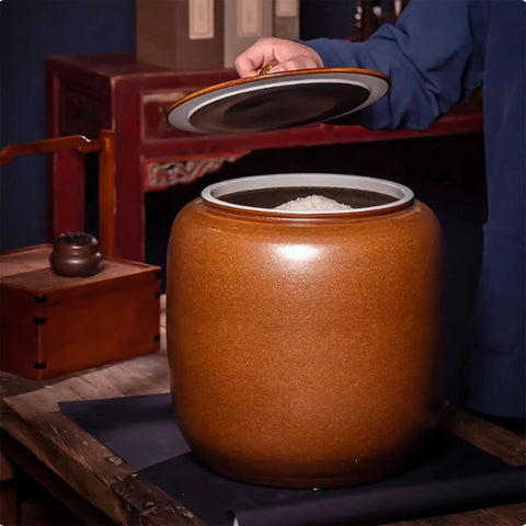Hella Durable Ceramic Cereal And Rice Dispenser With Seamless Airtight Lid, wide mouth opened with rice inside on wooden table.