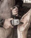 Craftsman using Turbo Shaft Freehand Power Carving Attachment for Angle Grinder on wood for deep carving lettering.