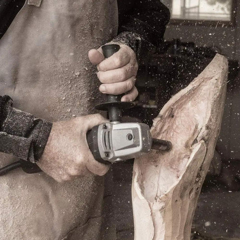 Craftsman using Turbo Shaft Freehand Power Carving Attachment for Angle Grinder on wood for deep carving lettering.