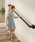 Rock Solid 3 Foot Adjustable Pipe Handrail For Indoor Outdoor Stairs Heavy Duty Wall Mounted Metal Safety Grab Bar Supporting 440 Lbs With No Sweat Setup For Bathrooms And Porches used by a child on indoor stairs.