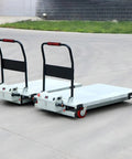 Shop Tough Electric Lifting Platform Cart Badass Motorized Lift Table With Four Smooth Wheels Straight Up. Motorized carts on a warehouse floor.
