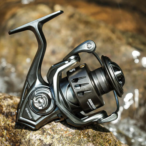 Ultra Smooth Spinning Reel With 12 Plus 1 Bearings, 5 To 1 Gear Ratio, CNC Aluminum Spool on rock by water