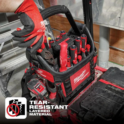 Person retrieving pliers from Packout 10 Inch Structured Tote For Tools And Gear, durable black organizer with red accents.
