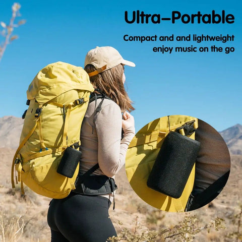 Person hiking with Compact Waterproof Portable Bluetooth Speaker That Goes Hard With Deep Bass, attached to yellow backpack.