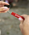 Person using handheld garden tool sharpener with tungsten carbide blade on pruning shears